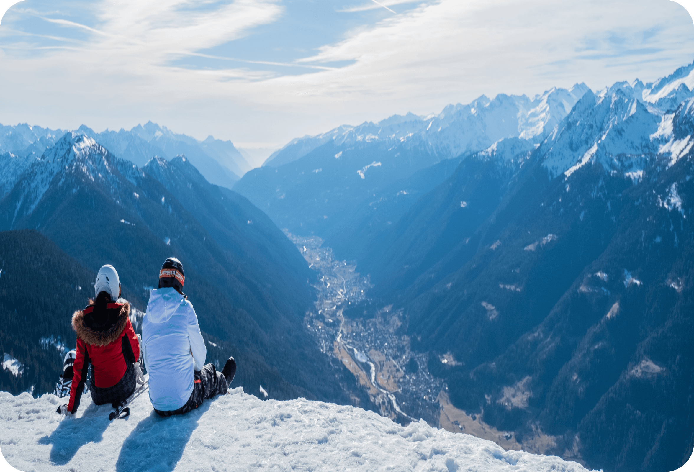 Two people are sitting on a mountain