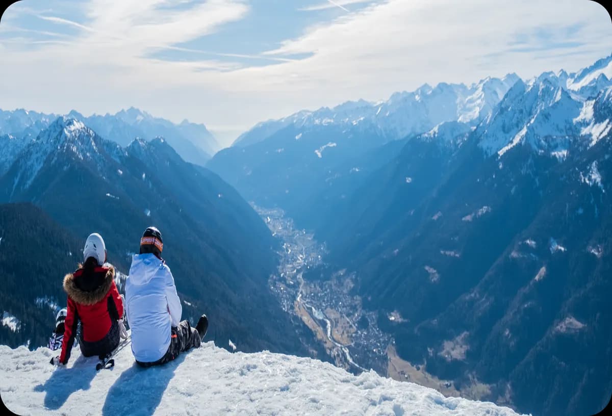 Two people are sitting on a mountain